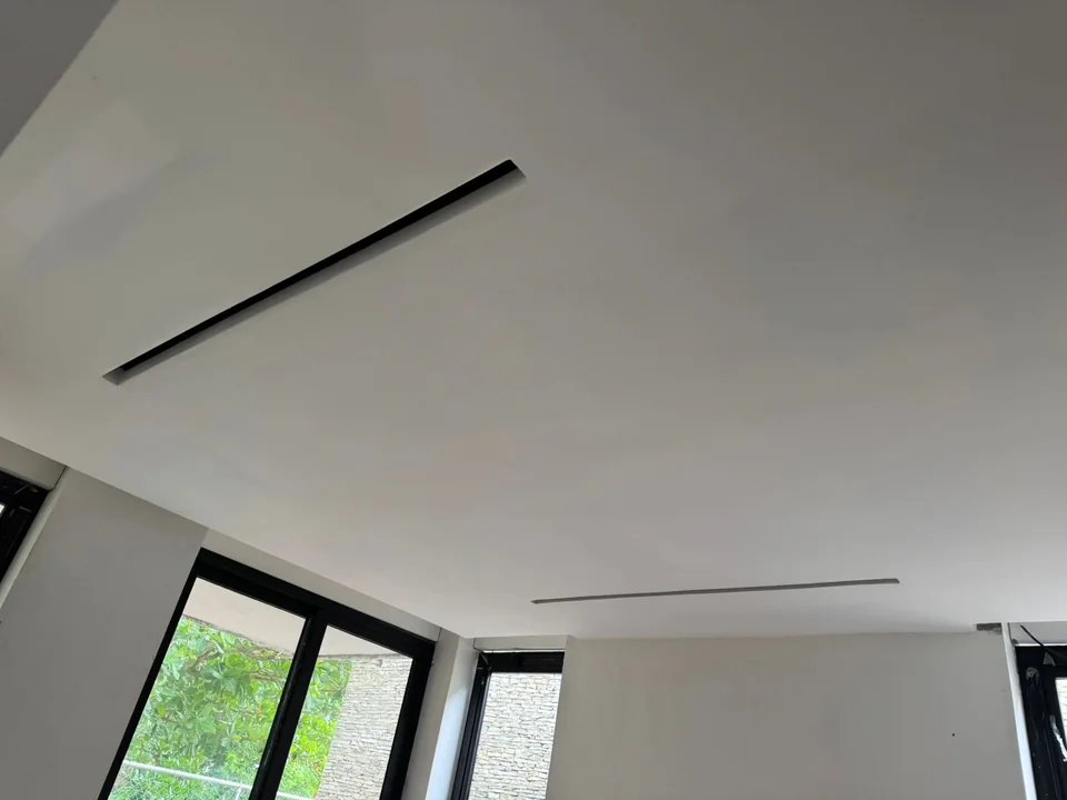 Linear diffusers integrated into the ceiling of a villa interior in Las Terrenas