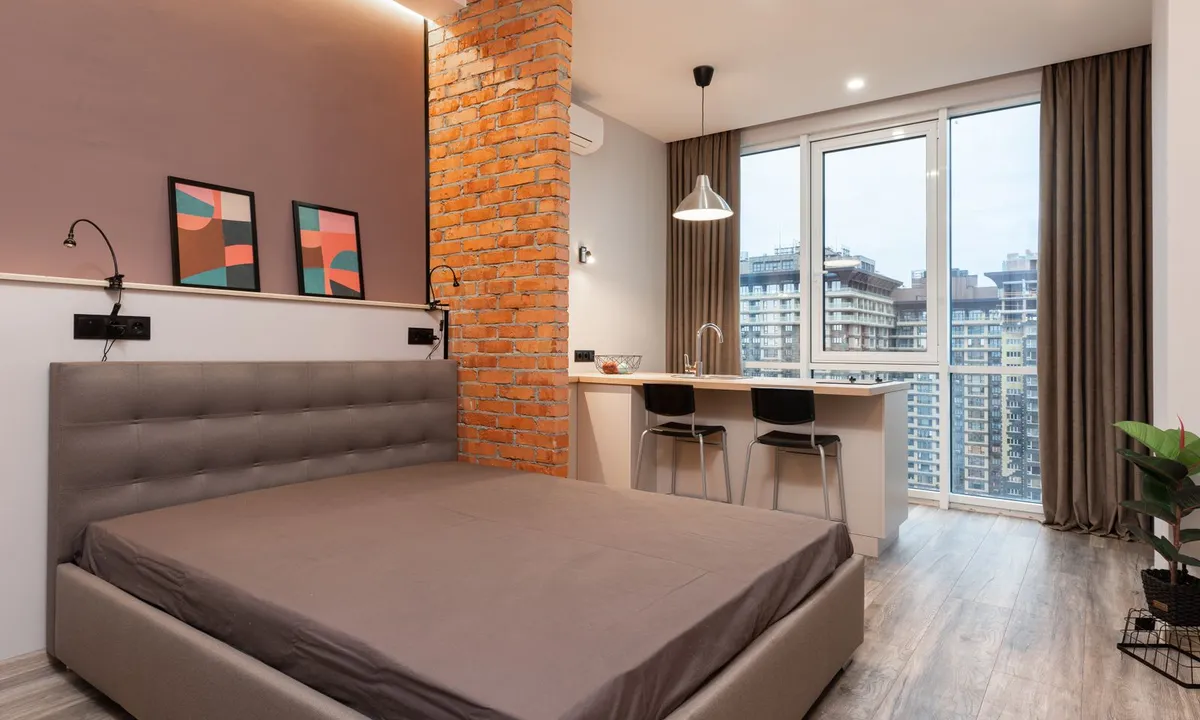 Apartment interior with a bed and dining area