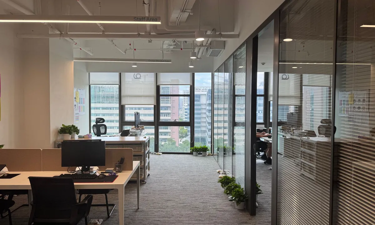 Office interior with workspaces beside windows