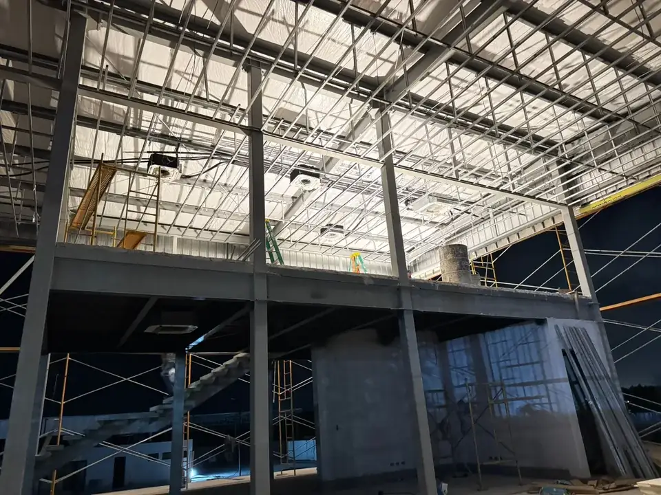 Commercial interior under construction with air-conditioning units installed in the ceiling